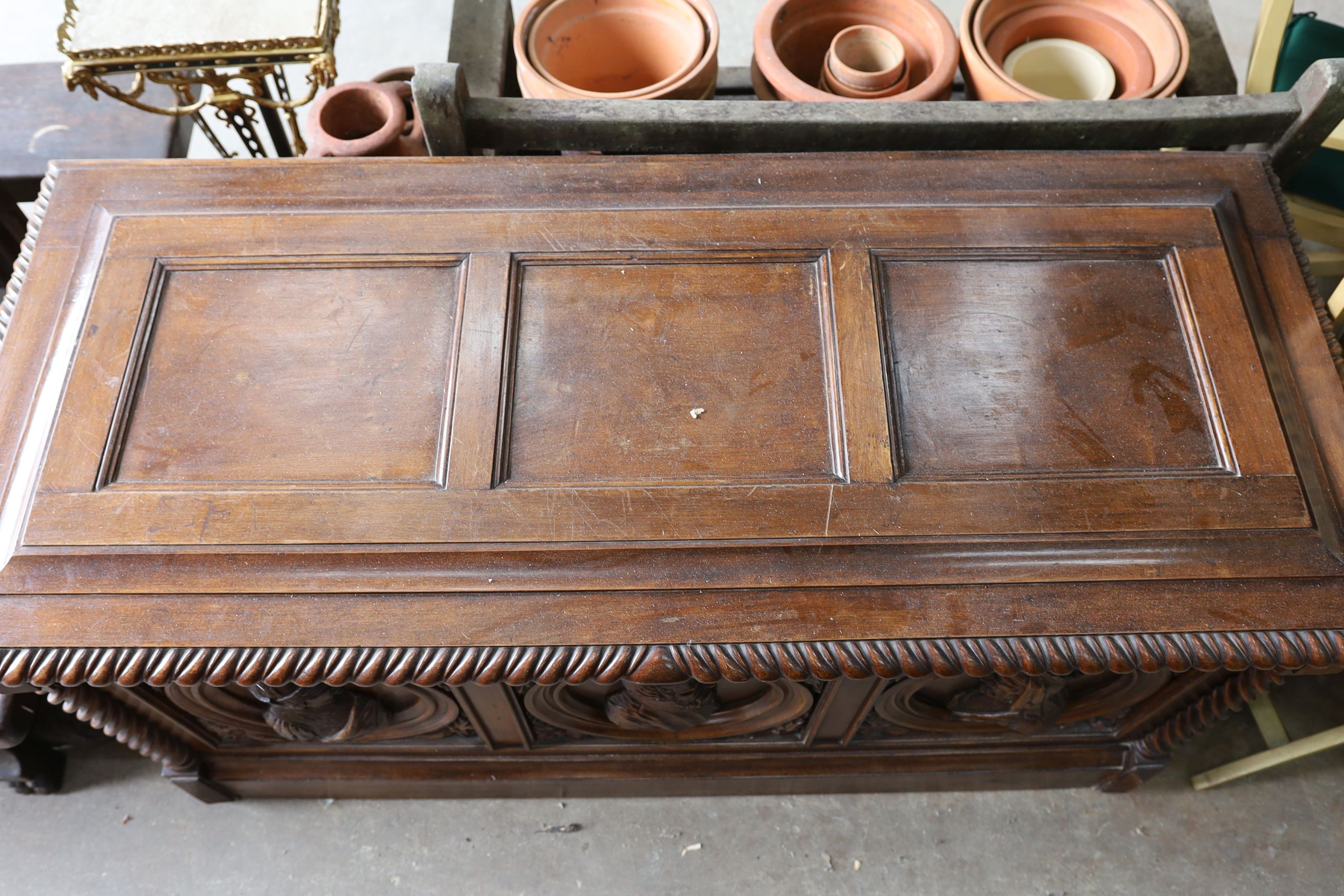 A 17th century style walnut cassone carved with busts in relief, width 160cm, depth 70cm, height 84cm